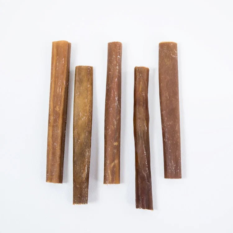 Five 6-inch natural beef collagen sticks for dogs aligned vertically on white background - Natural Dog Chew by Kathmandus
