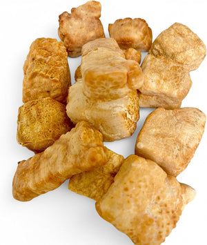 Close-up pile of crunchy yak cheese puffs on white background - Natural Dog Chew by Kathmandus